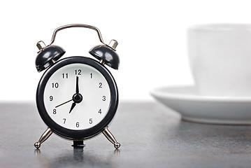 Image showing Alarm clock with cup of coffee