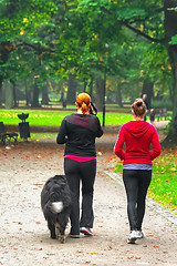 Image showing Two teenage with dog