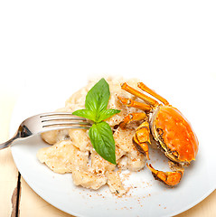 Image showing Italian gnocchi with seafood sauce with crab and basil