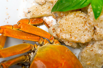 Image showing Italian gnocchi with seafood sauce with crab and basil