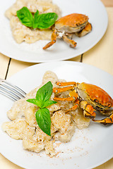 Image showing Italian gnocchi with seafood sauce with crab and basil