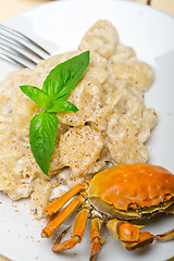 Image showing Italian gnocchi with seafood sauce with crab and basil