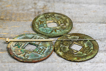 Image showing acupuncture needle on antique chinese coin