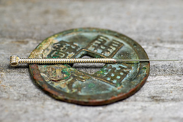 Image showing acupuncture needle on antique chinese coin