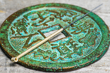 Image showing acupuncture needle on antique chinese coin