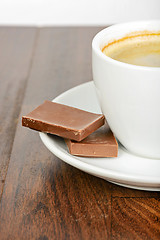 Image showing Half cup of coffee with chocolate on table