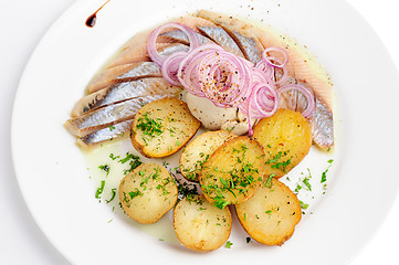 Image showing Roast potatoes with hering and onion
