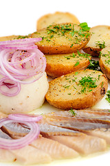 Image showing Roast potatoes with hering and onion