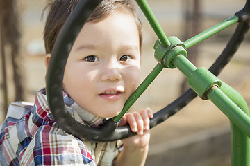 Image showing Mixed Race Young Boy Playing on Tractor