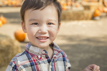 Image showing Mixed Race Young Boy Having Fun at the Pumpkin Patch