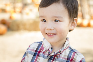 Image showing Mixed Race Young Boy Having Fun at the Pumpkin Patch