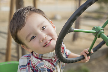 Image showing Mixed Race Young Boy Playing on Tractor