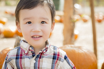 Image showing Mixed Race Young Boy Having Fun at the Pumpkin Patch