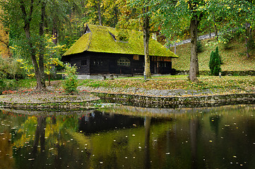 Image showing wooden house with moss on roof