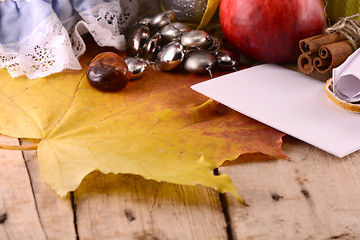 Image showing Autumn harvest. Apples, plums, grapes and yellow leaves on white background