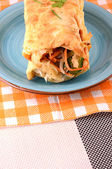 Image showing Burrito with tomatoes and cheese on blue plate