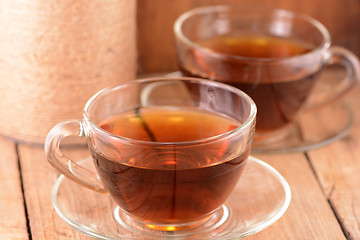 Image showing A cup of tea on wooden background