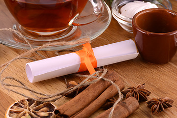 Image showing tea cup with white paper and cinnamon