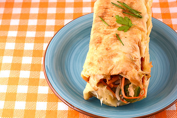 Image showing burrito with tomatoes and cheese on blue plate