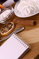 Image showing meringue, lemon and cinnamon on wooden backgroubd