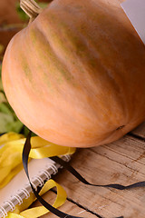 Image showing autumn background with pumpkin on wooden board