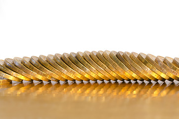 Image showing A number of coins lying on the Golden surface