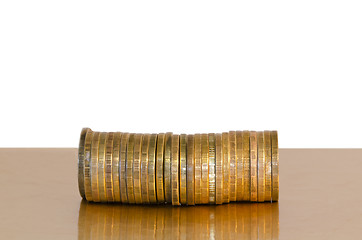 Image showing A stack of coins, placed horizontally on a white background