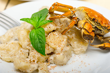 Image showing Italian gnocchi with seafood sauce with crab and basil