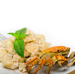 Image showing Italian gnocchi with seafood sauce with crab and basil