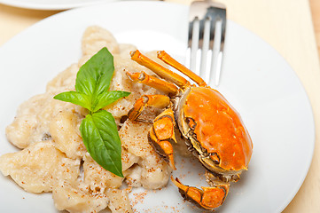 Image showing Italian gnocchi with seafood sauce with crab and basil