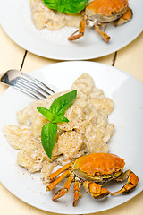 Image showing Italian gnocchi with seafood sauce with crab and basil