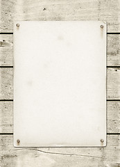 Image showing Blank vintage poster nailed on a white wood board