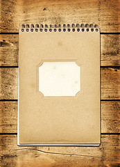 Image showing Blank vintage notebook on a wood board