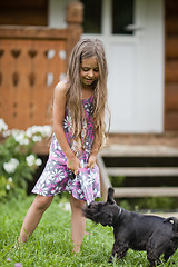 Image showing Little girl playing with her dog