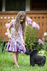 Image showing Little girl playing with her dog