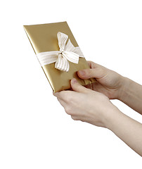 Image showing Young woman holding a present