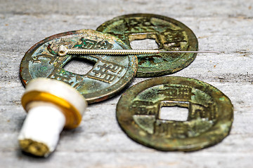 Image showing acupuncture needle on chinese coins