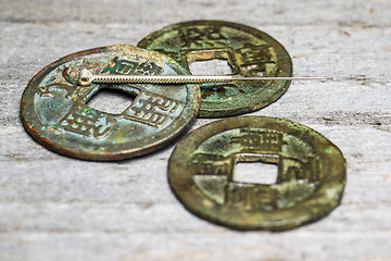 Image showing acupuncture needle on chinese coins