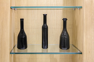 Image showing Three Empty black bottles