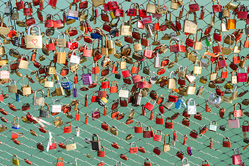 Image showing Plenty of colorful locks on bridge sign of eternal love devotion