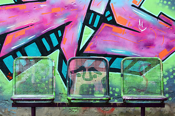 Image showing Street chairs in front of graffiti wall