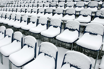 Image showing Stadium chairs covered in snow