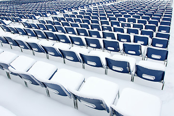 Image showing Plastic chairs covered in snow