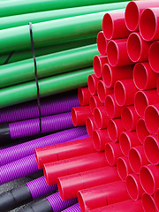 Image showing Stacks of colorful plastic pipes