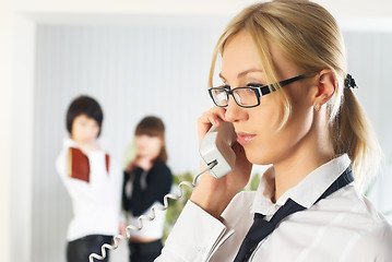 Image showing Calling attractive woman at colleagues background