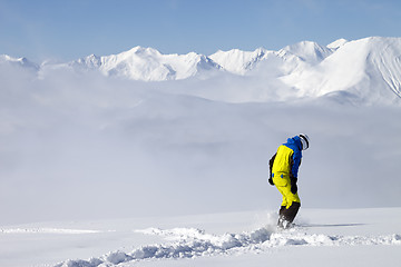 Image showing Snowboarder on off-piste slope with new fallen snow