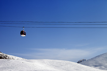 Image showing Gondola lift and ski slope at sun day