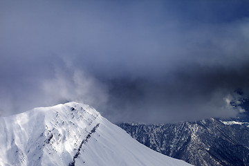 Image showing Sunlight top of mountains and storm clouds