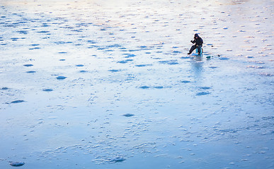 Image showing Ice Fishing On Frost Lake In Winter Time