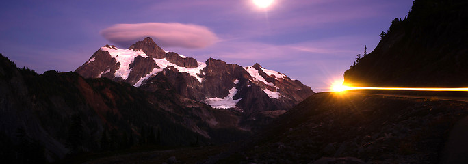 Image showing Lone Car Passes on Roadway Full Moon Mt Shuksan